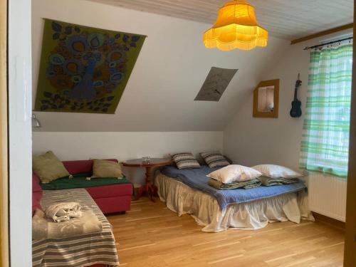 a room with two beds and a couch in it at Mejerikvillen in Fliseryd