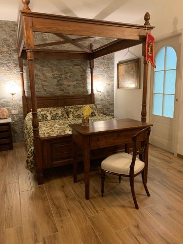 a bedroom with a canopy bed with a desk at Ca' Boscodonne in Calosso