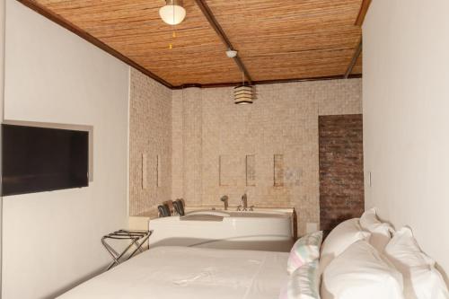 a bathroom with a tub and a sink at Placita Vieja Hotel Boutique Spa in Santa Marta