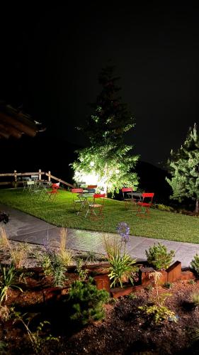 a group of tables and chairs in a yard at night at Ca' De Sass in Pila