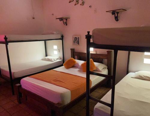 a bedroom with two bunk beds and a room with two at La Casa del Viajero Mompos in Mompos