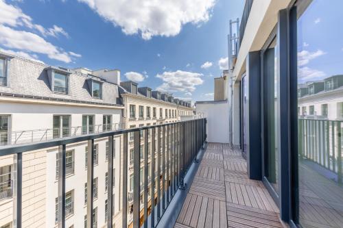a balcony with a view of buildings at Quartier Libre Opera in Paris