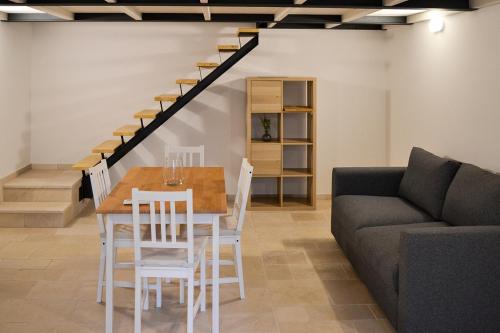a dining room with a table and a couch at Dimora Manzoni in Noci