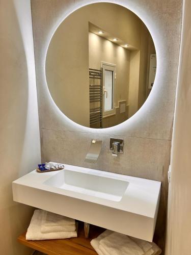 a bathroom with a white sink and a mirror at Mael Superior Room in Palermo