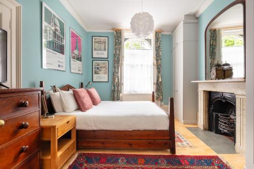 a bedroom with a bed and a fireplace at Ultra Central London, Garden, King Bed in London