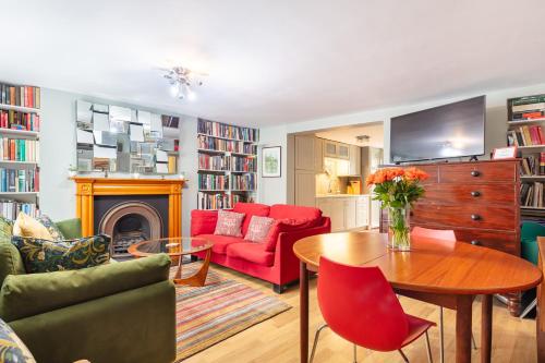a living room with a couch and a table at Ultra Central London, Garden, King Bed in London