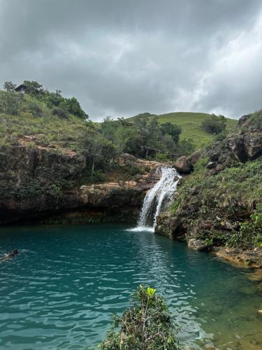 a waterfall in the middle of a river at Playa Escondida in Loma del Naranjo