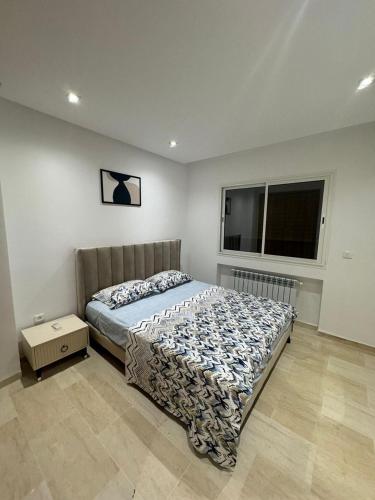 a bedroom with a bed and a window at The pearl of Aouina - Modern Splus2 luxurious apartment in La Goulette