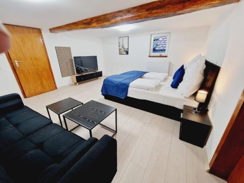 a large bedroom with a bed and a couch at Laubach Apartments in Laubach