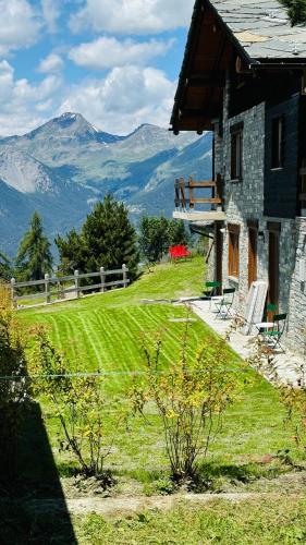 a house on a hill with mountains in the background at Ca' De Sass in Pila