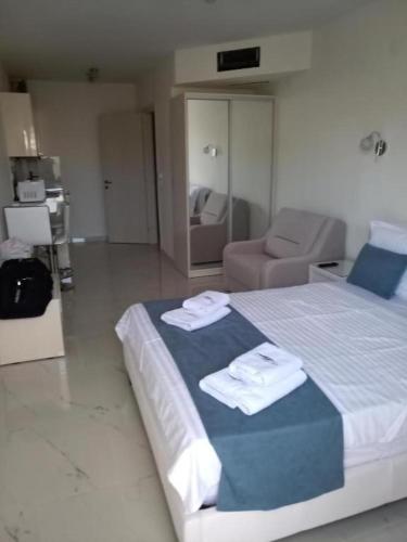 a bedroom with a large bed with towels on it at Villa Nikiti View semi-basement in Nikiti