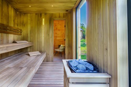 Novi VladimirovacEspacio Resort - Pool & Spa的客房设有带长凳和窗户的桑拿浴室。