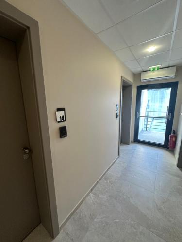 an empty hallway in an office building with a door at ADRIA MIRIS apartments in Drasnice