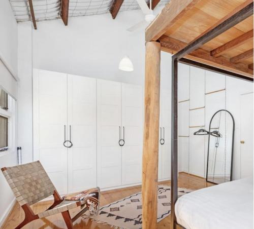 a bedroom with a bed and a chair at 5 North Freo 2br Supercool Pad & Parking in North Fremantle