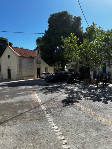 a street with a parking lot in front of a building at Evdokiahouse in Áno Kalésia