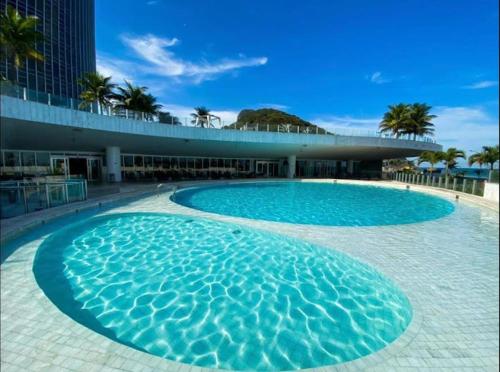 a large blue swimming pool in front of a building at Hotel Nacional in Rio de Janeiro