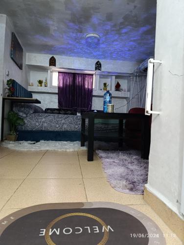 a room with a table and a purple ceiling at Alone Studio in Casablanca