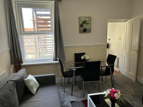 a living room with a couch and a table at Zinoc Delight, free parking, at City centre, close to the sea & lovely places in Blythe