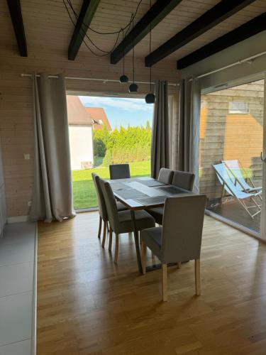 a dining room with a table and chairs at Jaśminowy Sad in Mikołajki