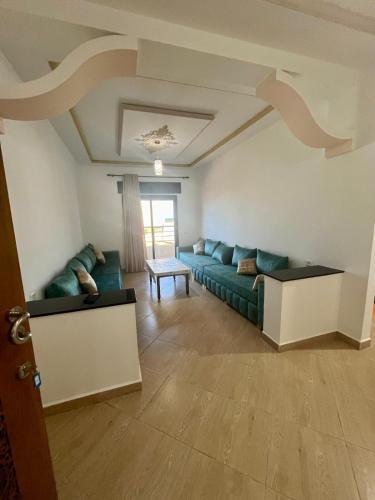 a living room with a couch and a table at Paraiso Costero Azla Tetouan in Azla