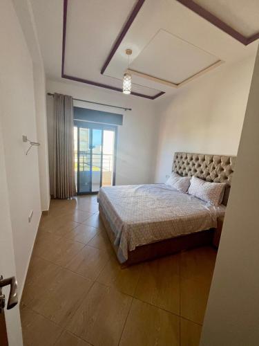 a bedroom with a bed and a large window at Paraiso Costero Azla Tetouan in Azla