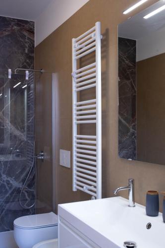 a bathroom with a shower and a toilet and a sink at La casa di mest Pepp in Monopoli
