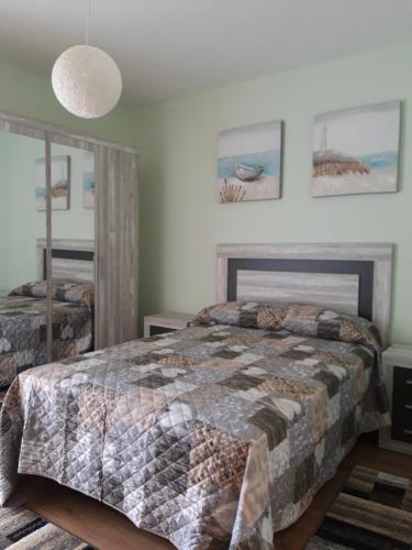 a bedroom with two beds and a mirror at Casa Lavandeira in Ourense