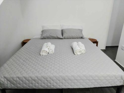 a bed with two towels and two pillows on it at Historic Downtown in Vila Real