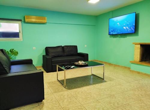 a living room with a couch and a coffee table at SleepiLi in Vrísai