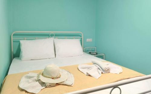 a hospital bed with a hat and towels on it at SleepiLi in Vrísai