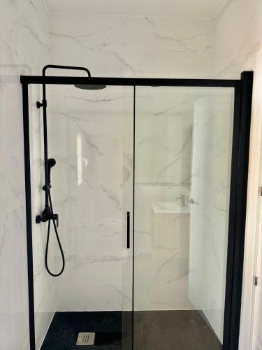 a shower with a glass door in a bathroom at Apartamentos El Llano Dorado 15 in Sorbas