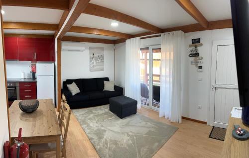 a living room with a couch and a table at Acolhedora casa de férias T2 com espaço exterior in Esmoriz