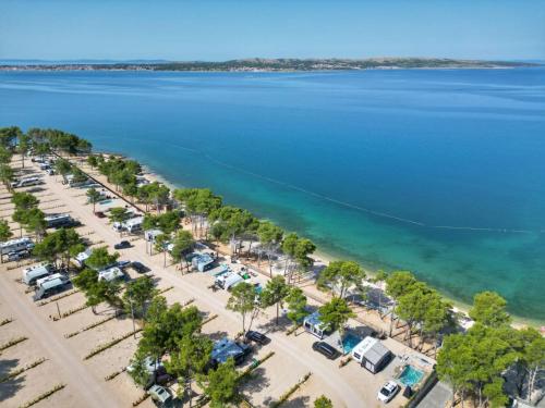 an aerial view of a parking lot and the ocean at Aminess Style Camping Avalona Resort - Pitches in Povljana