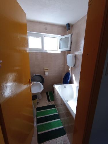 a small bathroom with a sink and a toilet at Vesela vila in Sutomore