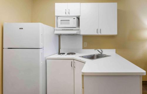a kitchen with a white refrigerator and a microwave at Extended Stay America Suites - Phoenix - Chandler in Phoenix