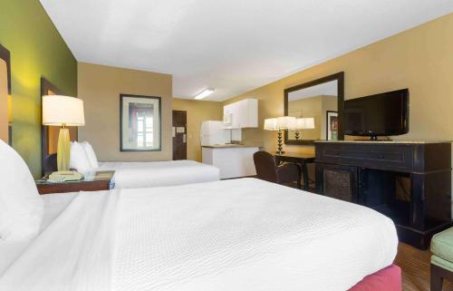 a hotel room with two beds and a desk at Extended Stay America Suites - Phoenix - Chandler in Phoenix