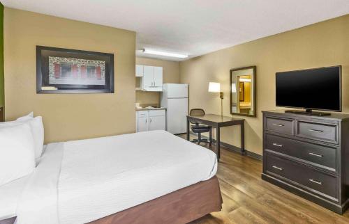 a hotel room with a bed and a flat screen tv at Extended Stay America Suites - Sacramento - Northgate in Sacramento