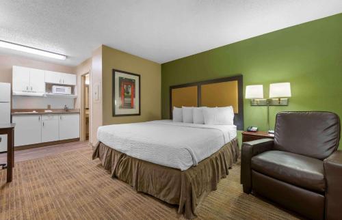 a hotel room with a bed and a chair at Extended Stay America Suites - Sacramento - Northgate in Sacramento