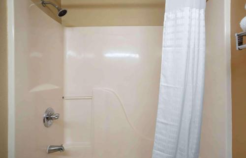 a shower with a white shower curtain in a bathroom at Extended Stay America Suites - Mobile - Spring Hill in Mobile