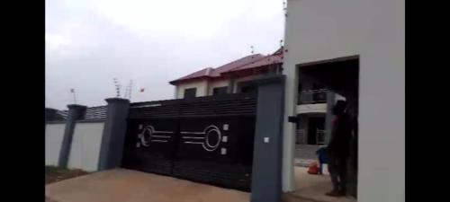 a black fence with a sign on it in front of a building at Purple Springs Elmina #2 in Brunibuma