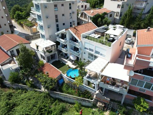 an aerial view of a building with a swimming pool at Apartmani Amra in Ivanovići
