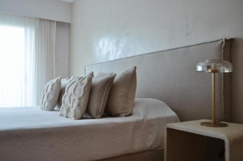 a bedroom with a bed with pillows on it at Le Bibló in Montevideo