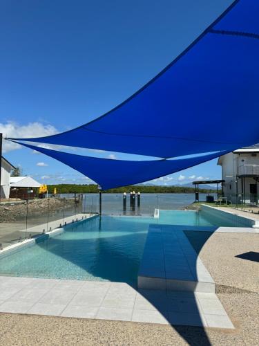 a blue canopy over a swimming pool at Lucinda Cove Resort in Lucinda