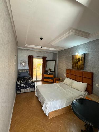 a bedroom with a bed and a table in it at Ouzoud le Panorama in Ouzoud