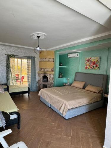 a bedroom with a large bed and a fireplace at Ouzoud le Panorama in Ouzoud