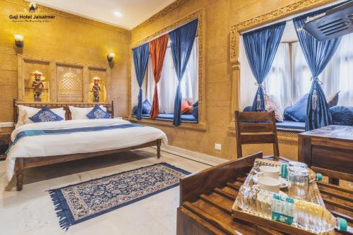 a bedroom with a bed and a desk at Gaji Hotel Jaisalmer in Jaisalmer