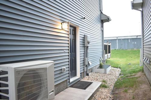 a door to a house with a fan next to it at Cozy escape! 2 BR Guest Suite! 2 Queen Beds! Complimentary WIFI Netflix & Parking! 11 Mins from YEG! 20 Mins from WEM! in Edmonton