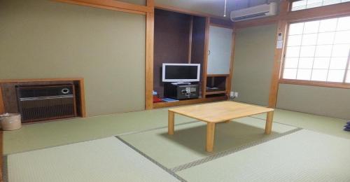 a living room with a table and a television at Takayama - Hotel / Vacation STAY 15860 in Takayama