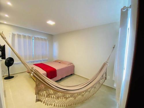 a bedroom with a bed and a hammock at LD House- Bananeiras in Bananeiras