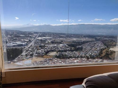 a view of a city from a window at Vista Real Modern View Jacuzzi hidromasaje in Quito